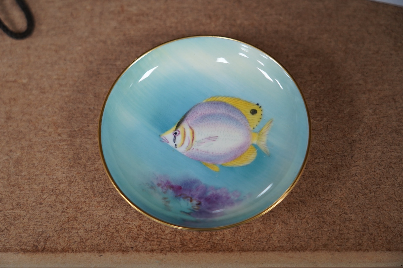 A Royal Worcester 'Four Eyed Fish' dish, signed, 9cm diameter. Condition - good